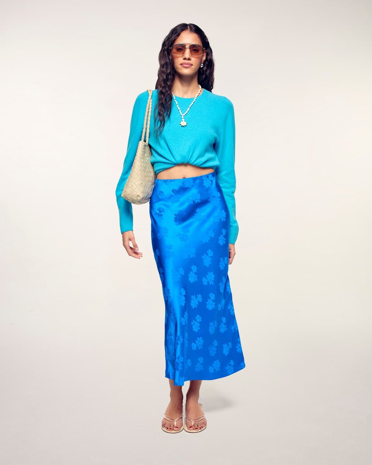 Model in a blue jacquard satin midi skirt