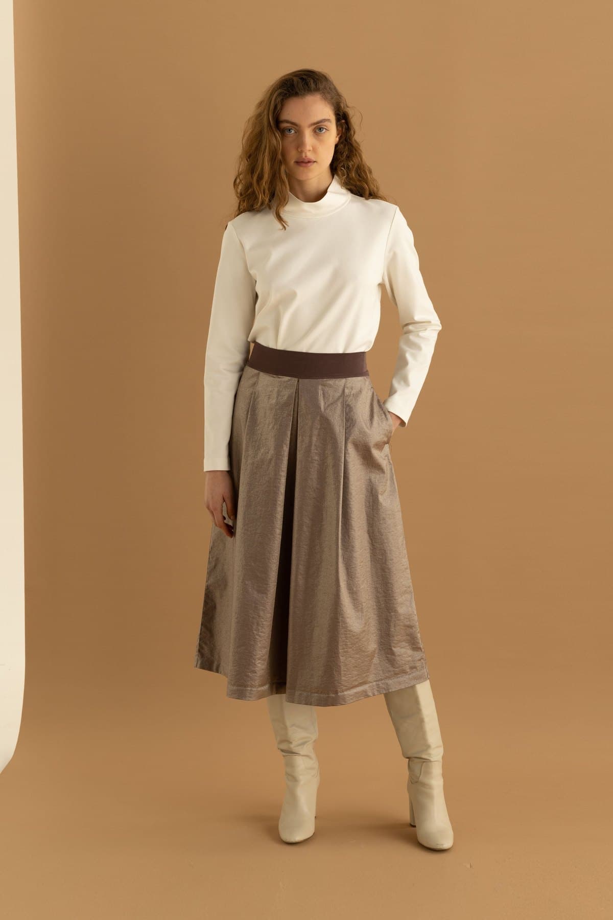 Model in an ivory A-line midi skirt