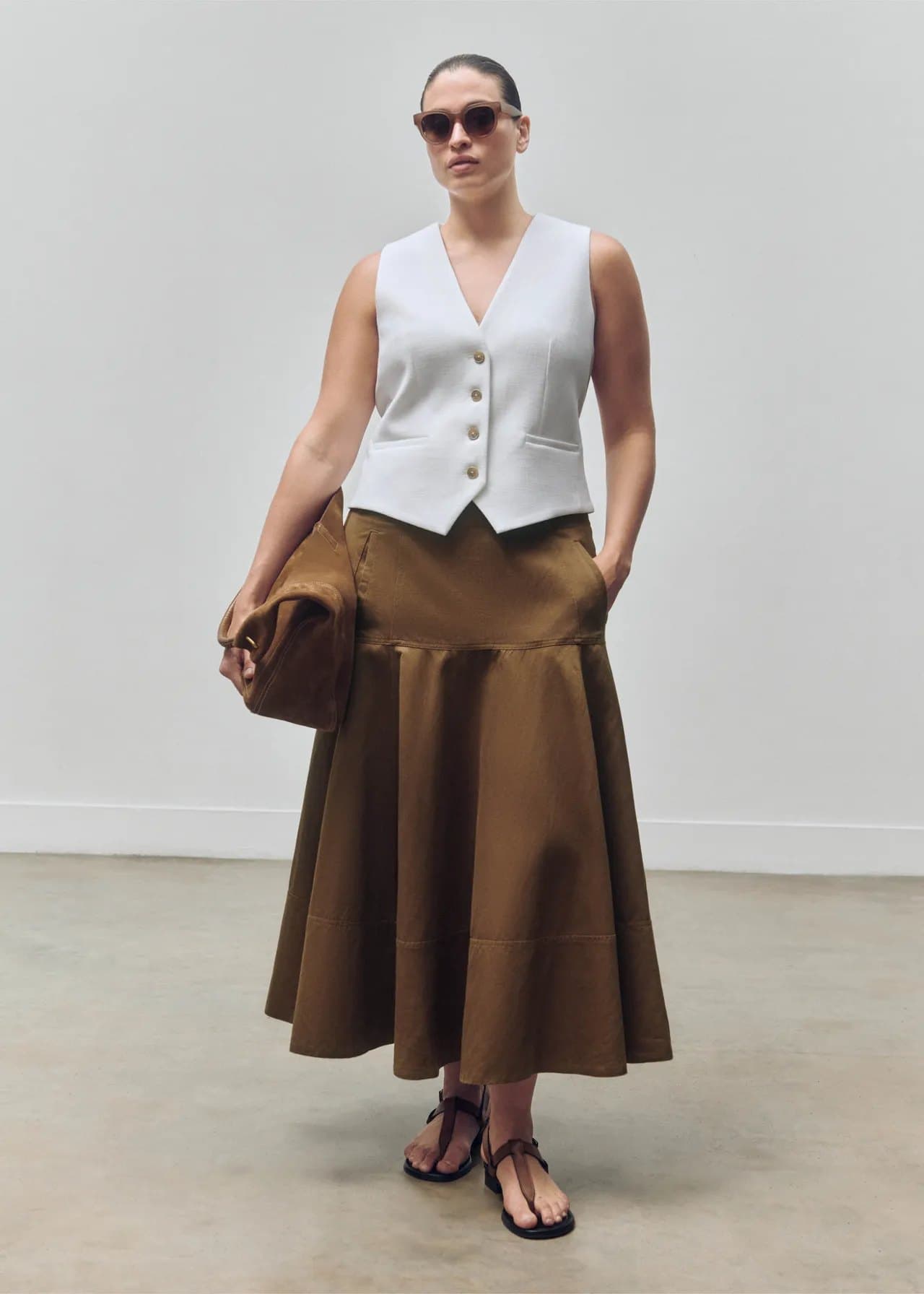 Model in an olive satin A-line midi skirt