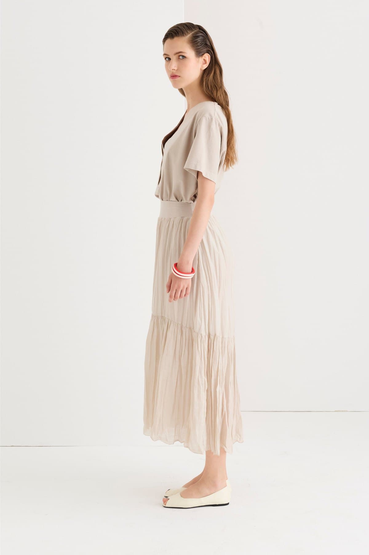 Side view of a beige voile maxi skirt