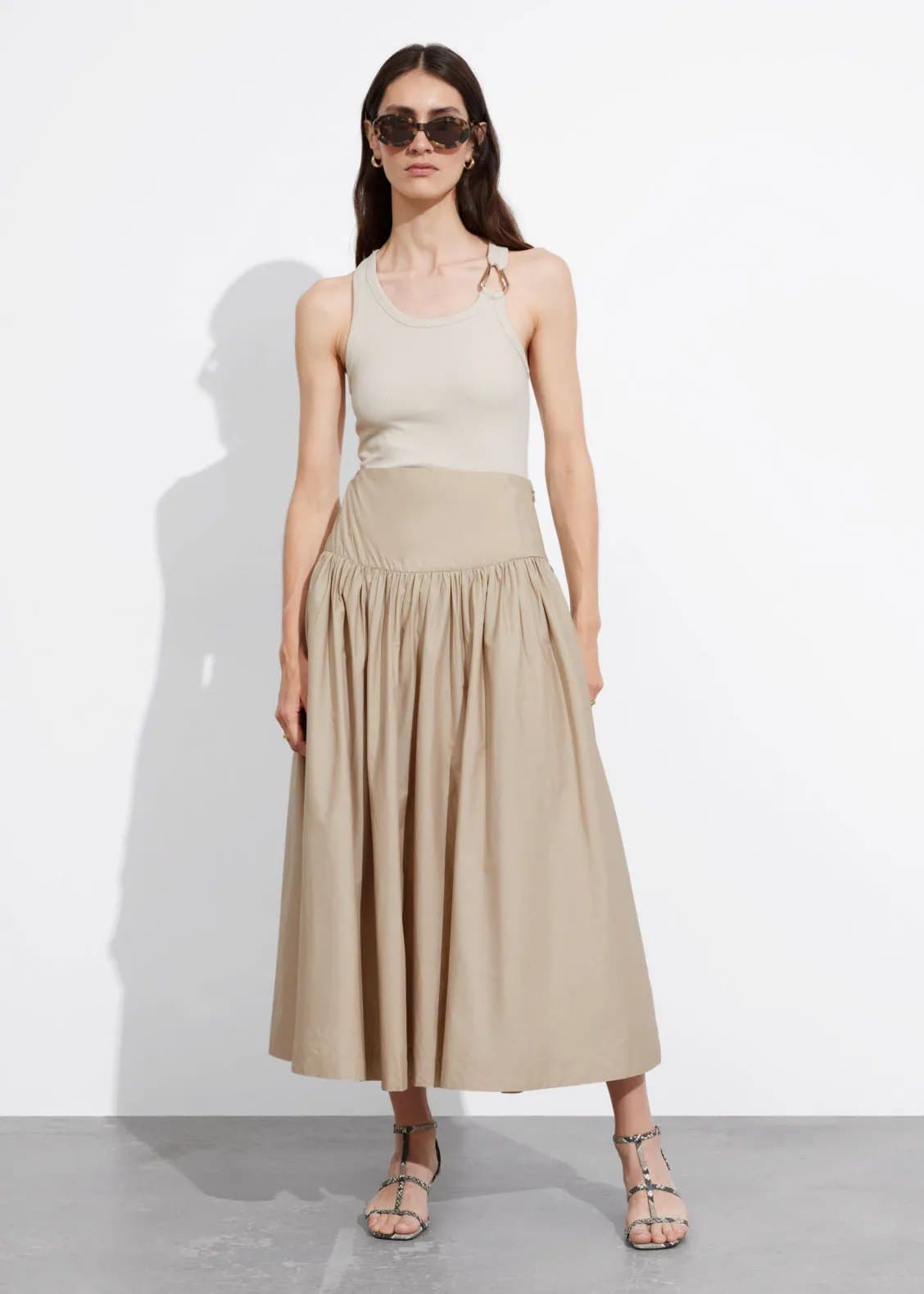 Model in a stone drop-waist midi skirt