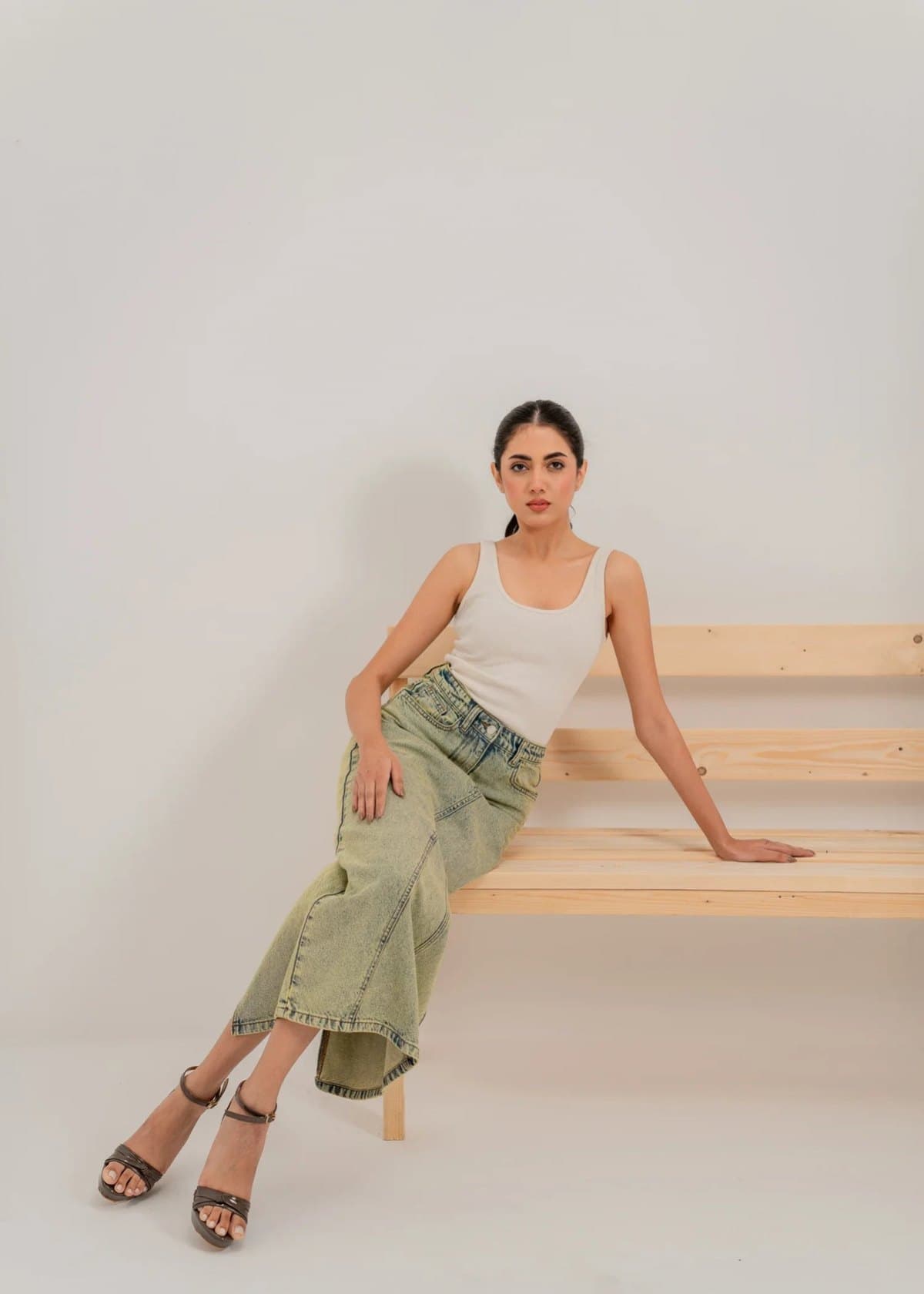 Model in a green washed-denim midi skirt