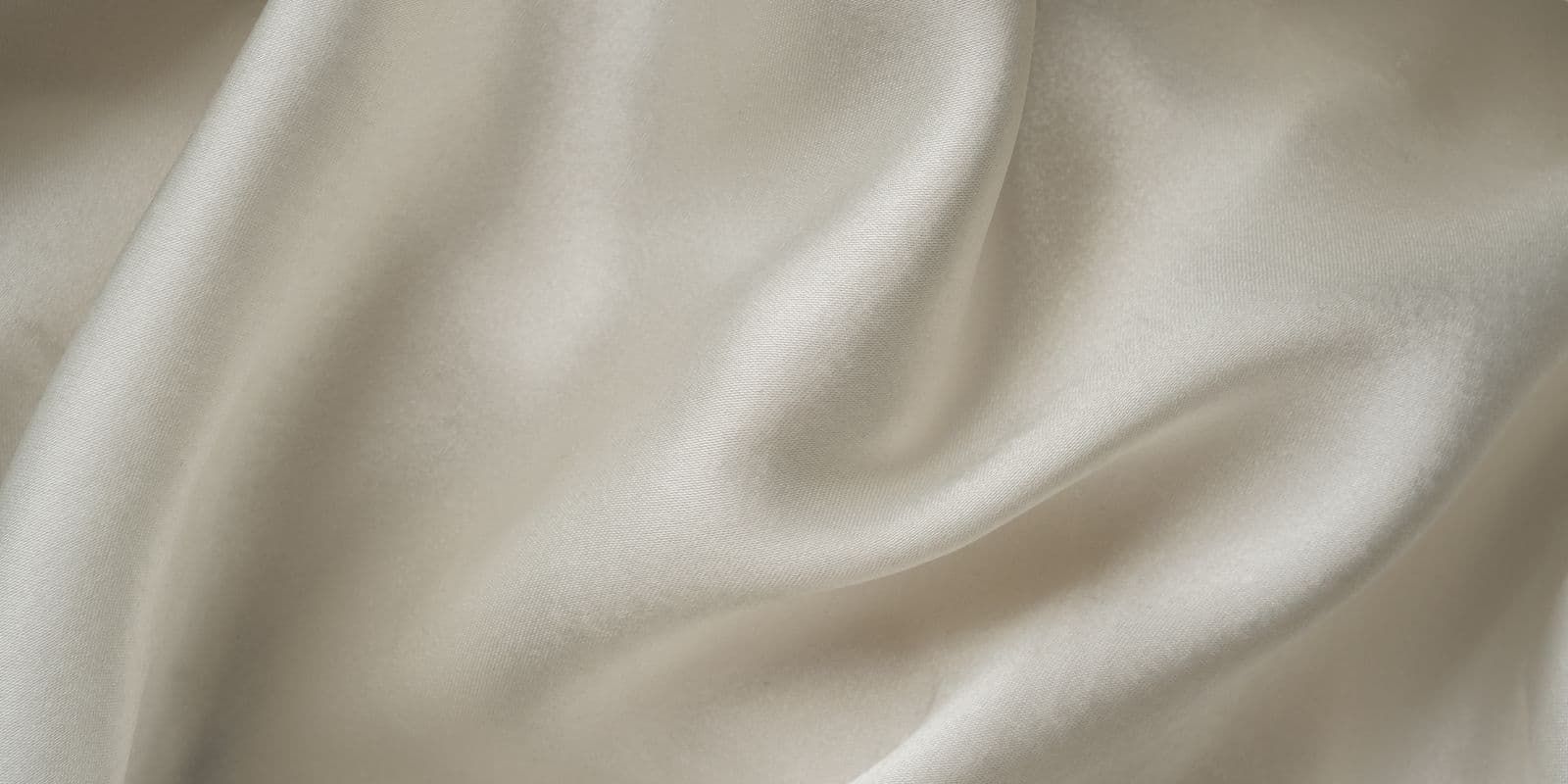 Ivory champagne satin fabric in close detail