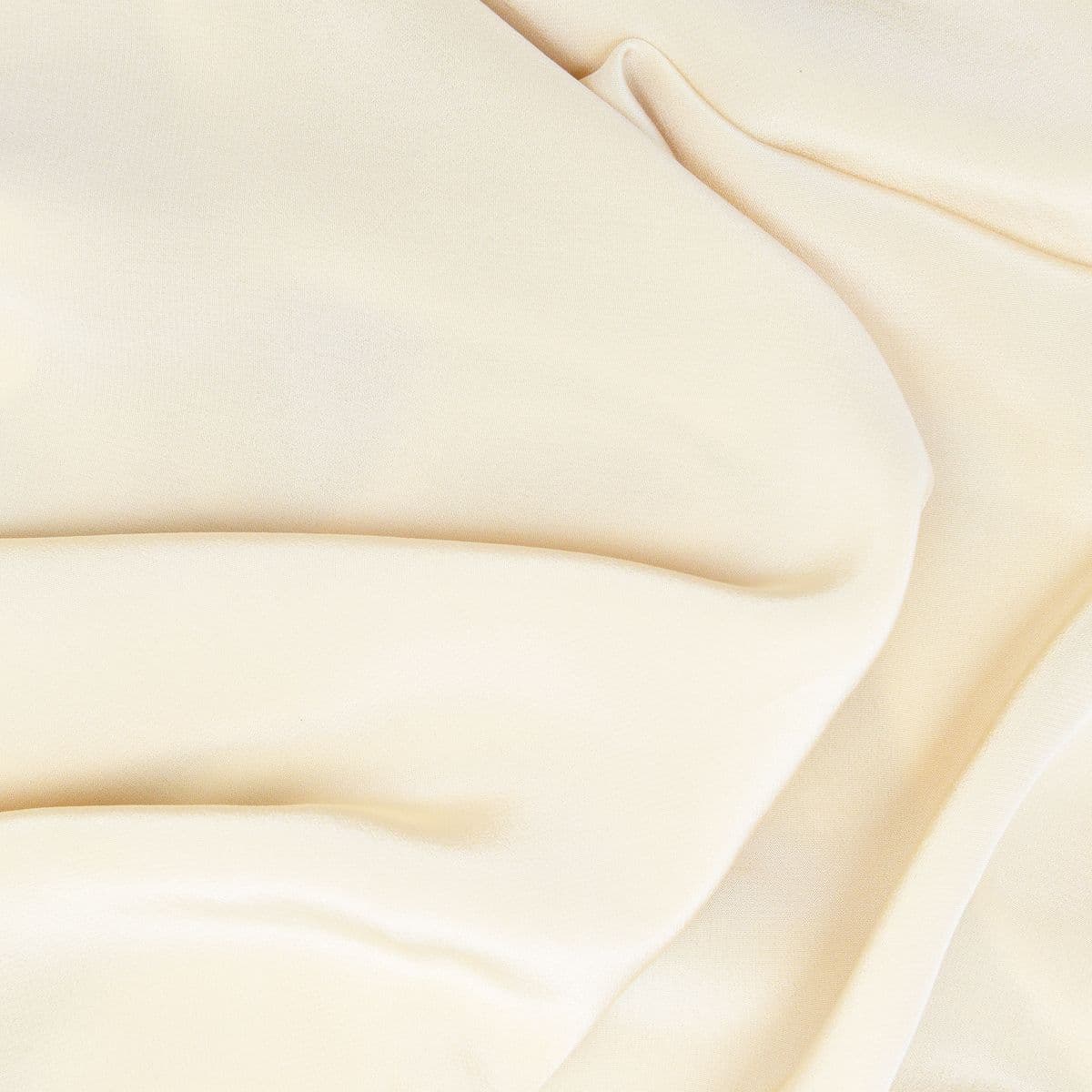 Warm ivory satin fabric in soft folds