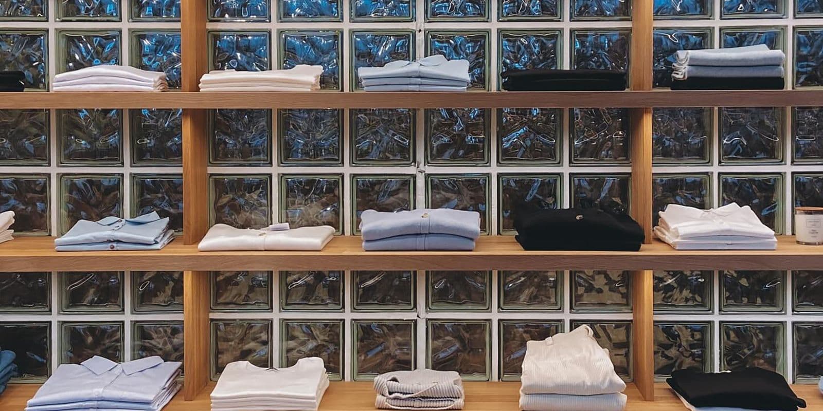 Neatly folded shirts arranged on shelves