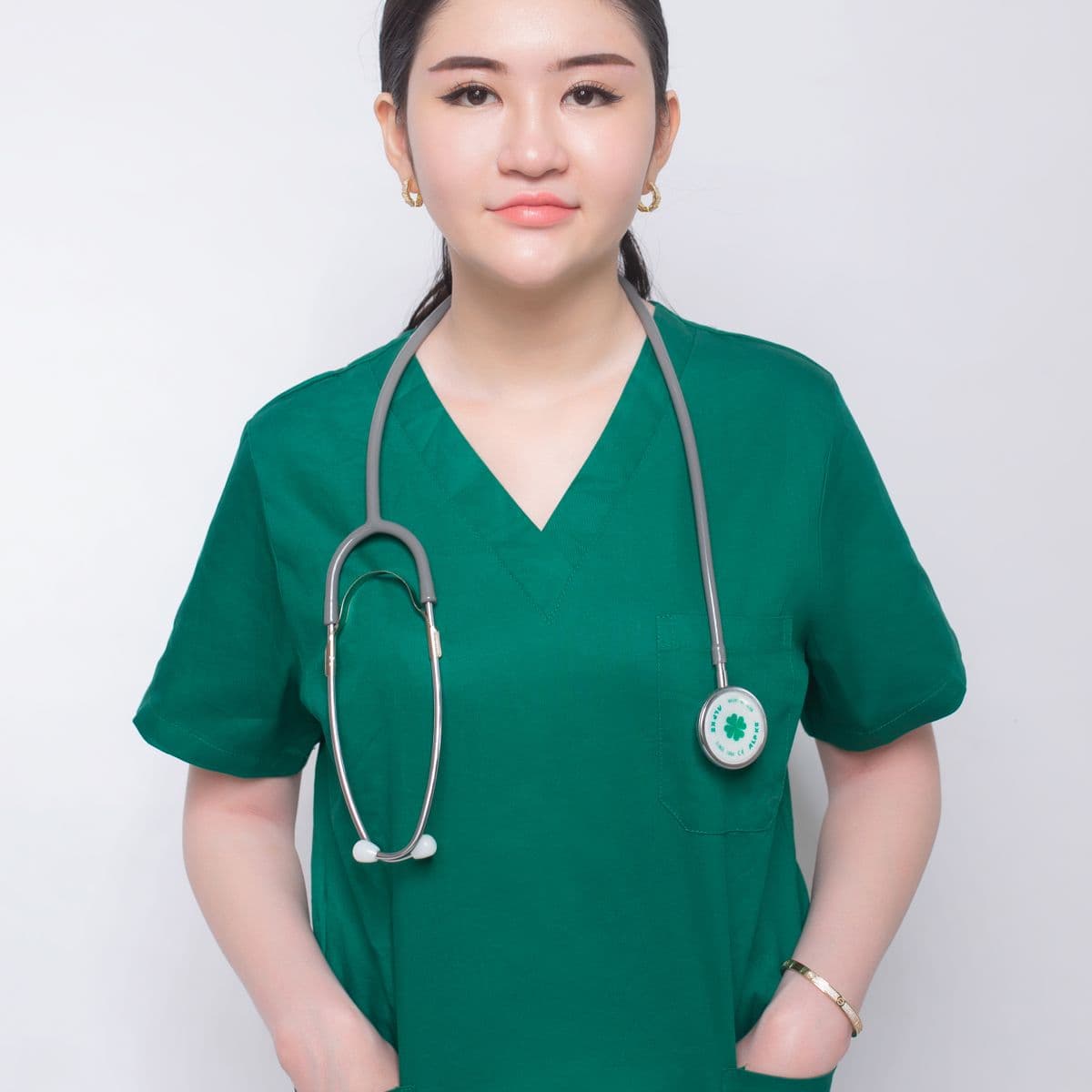 Healthcare worker in green V-neck scrubs