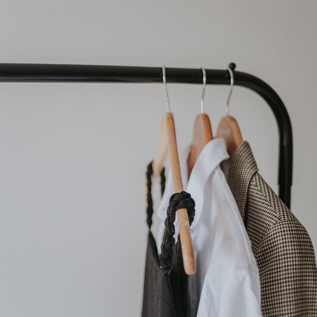 A crisp white shirt and tailored jacket on a garment rail