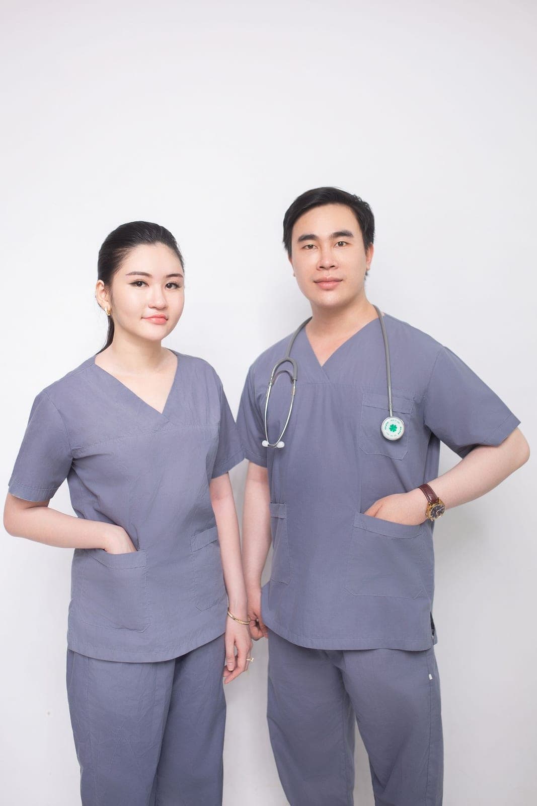 Two nurses in teal scrubs