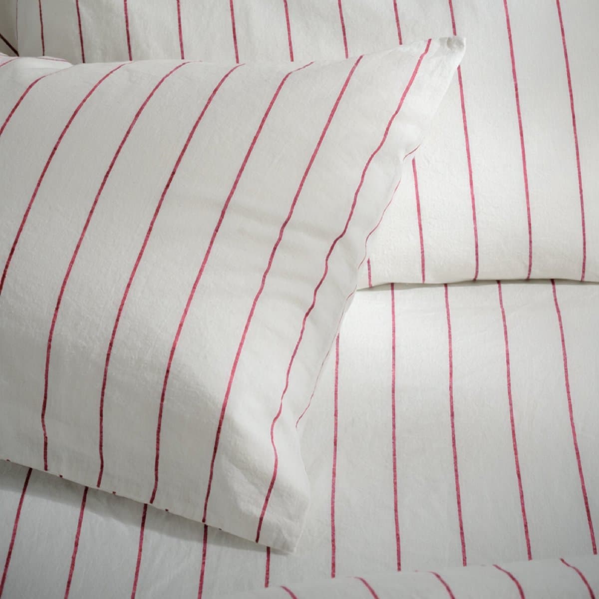 White cotton draw sheet with a red stripe