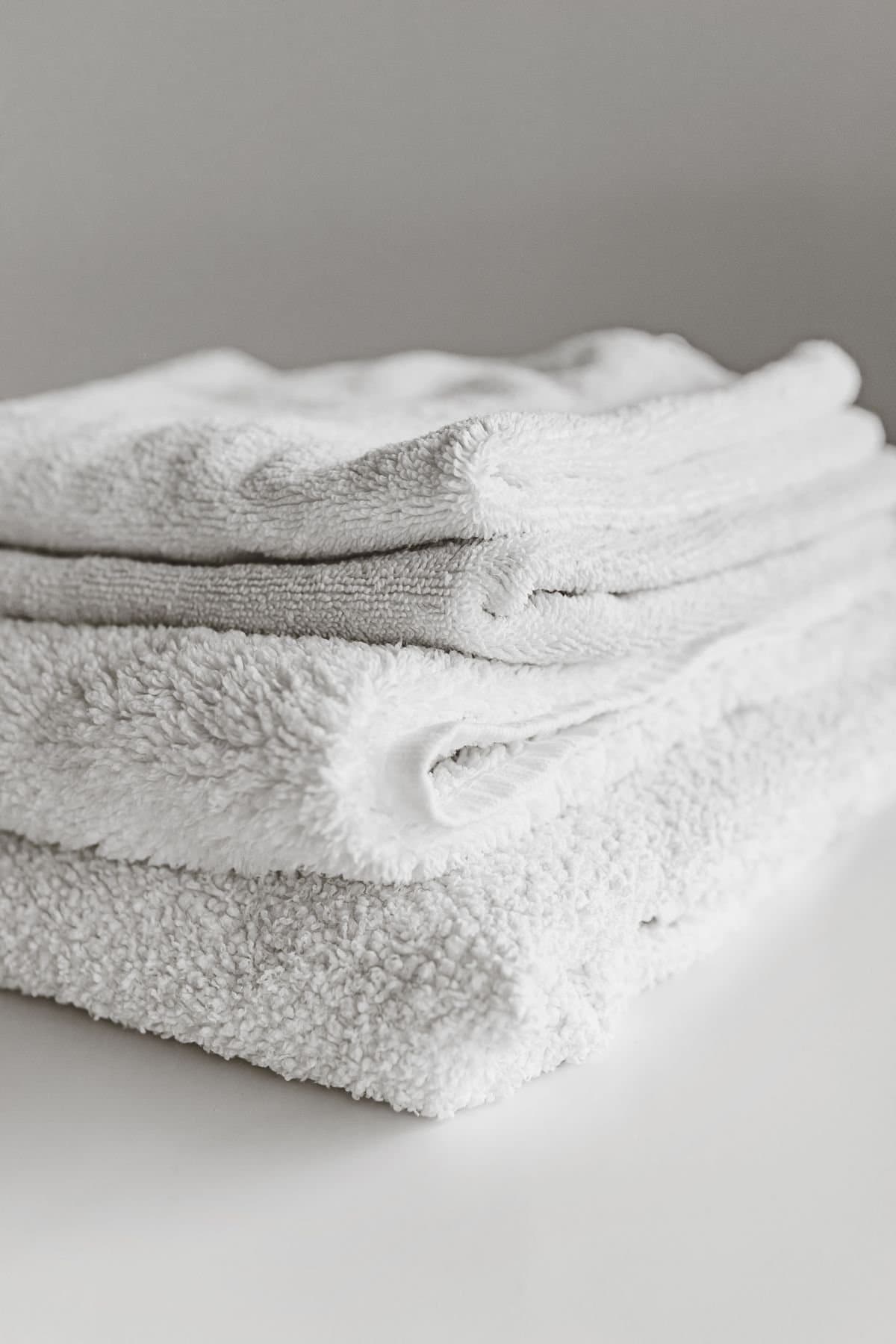 A neat stack of folded white cotton linen