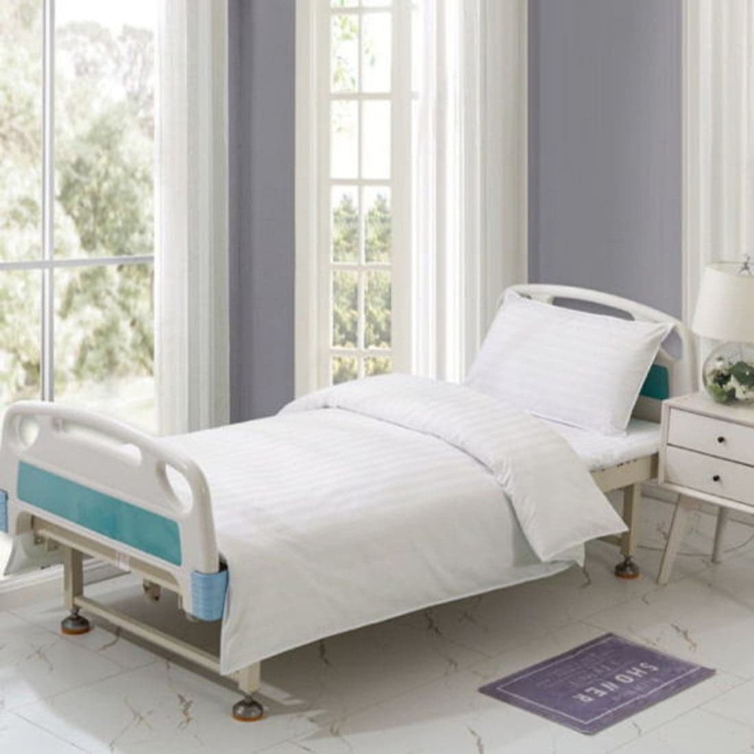 A hospital bed in white striped linen
