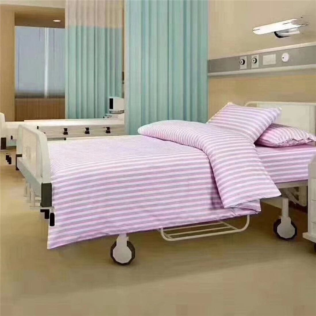 A hospital bed in pink striped linen