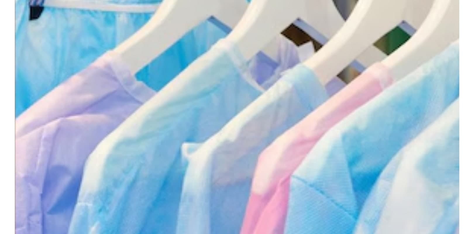 A rail of patient gowns in soft colours