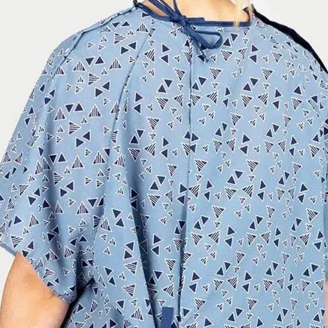 A printed blue patient gown with neck and waist ties