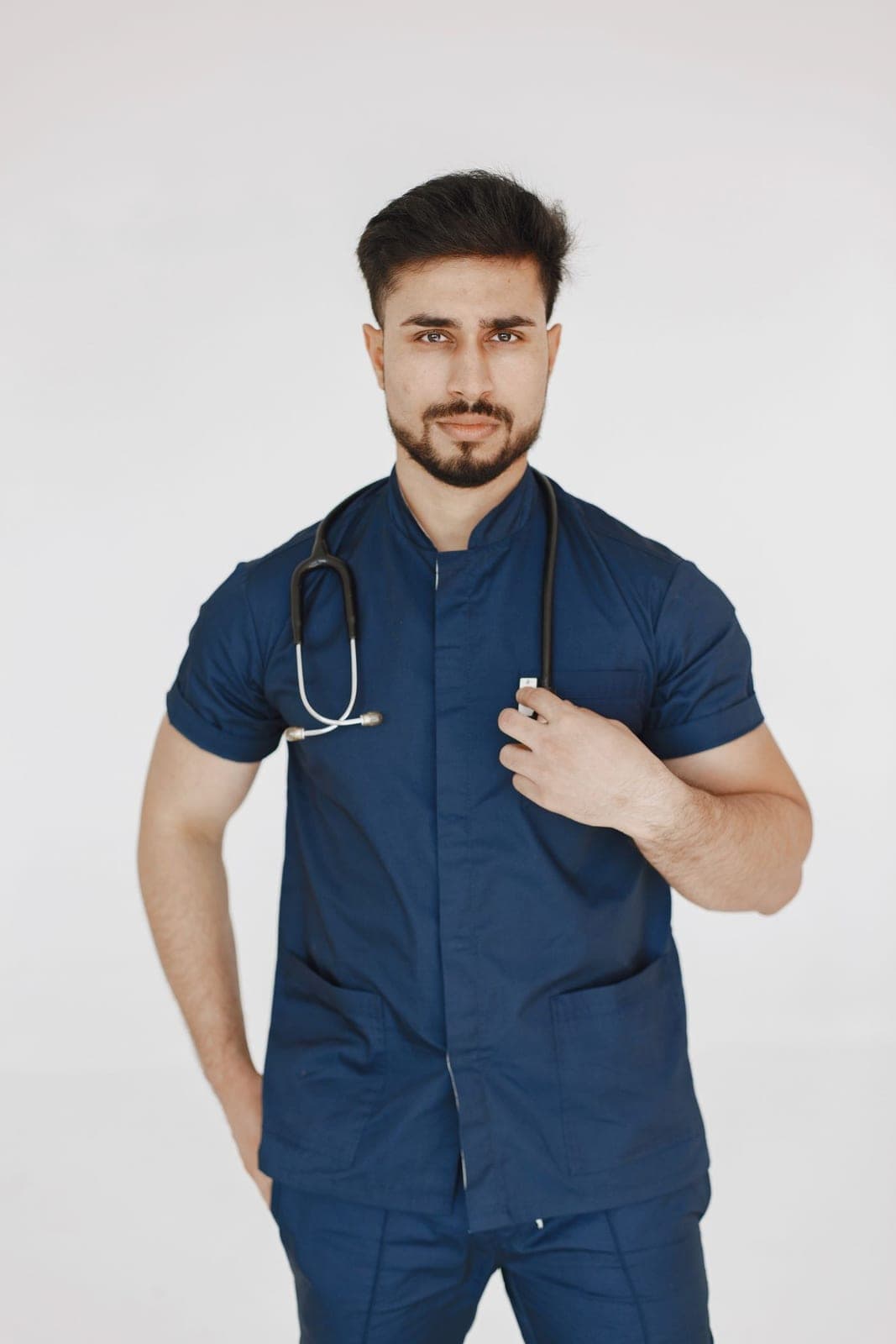 A healthcare worker in navy medical scrubs