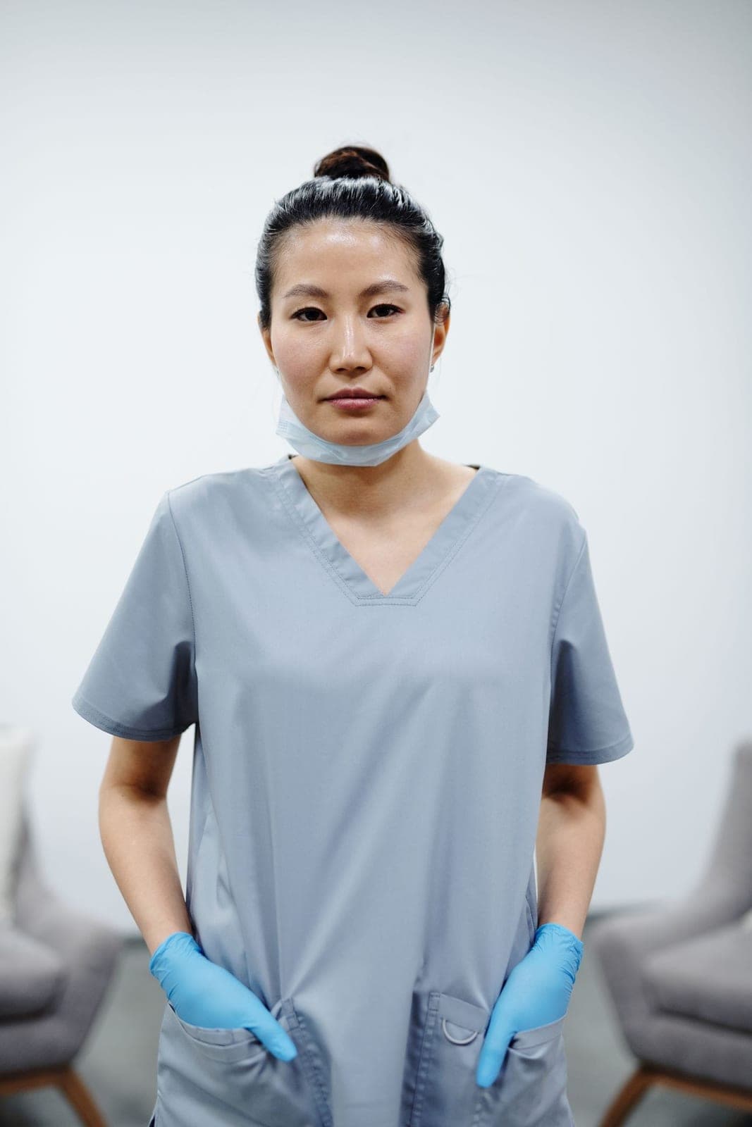 A clinician in soft grey scrubs