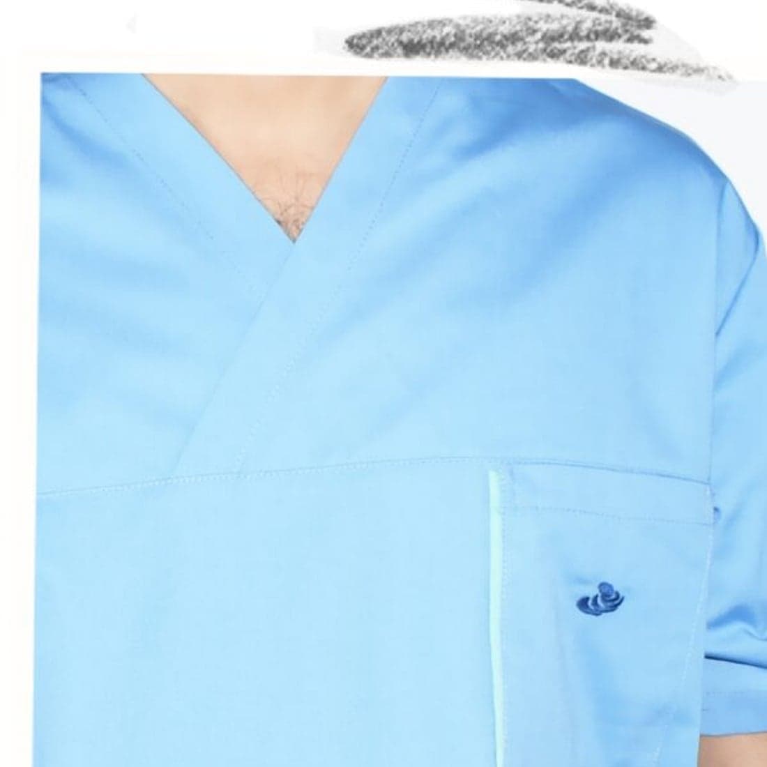 A blue medical scrub top in detail