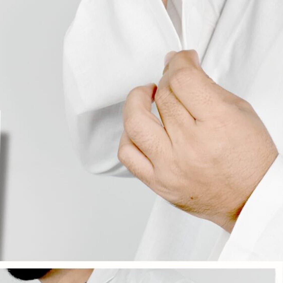 Cuff detail of a white medical coat