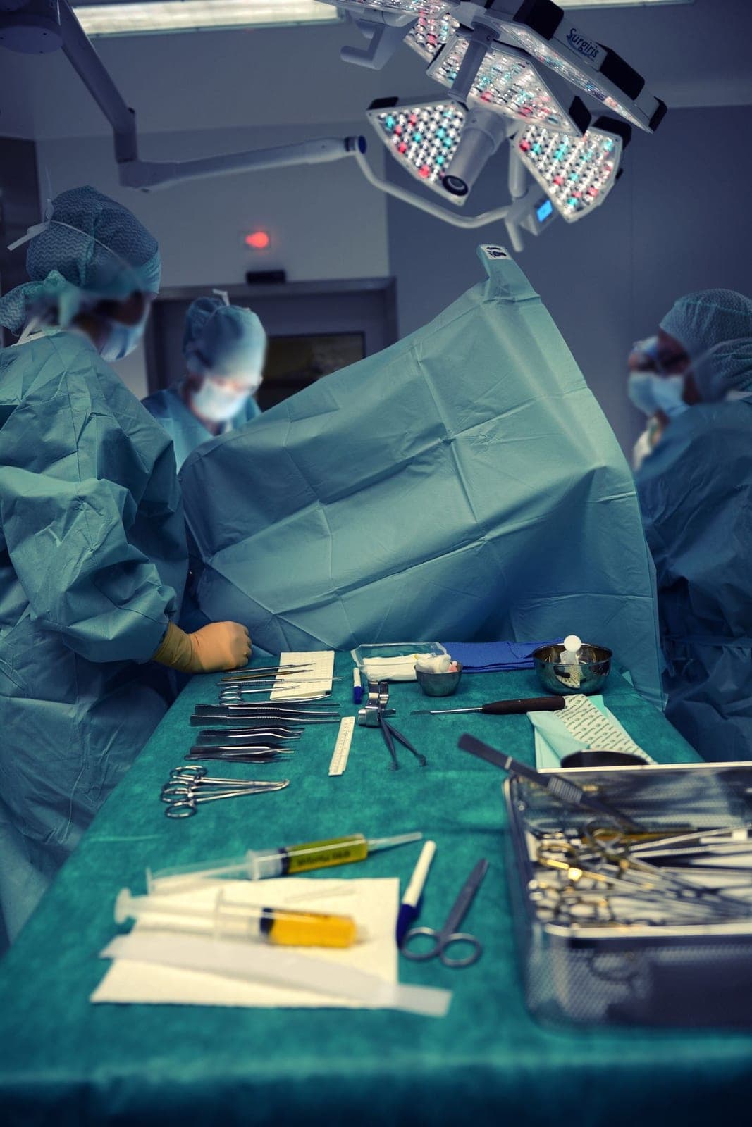 A green surgical drape with instruments laid out