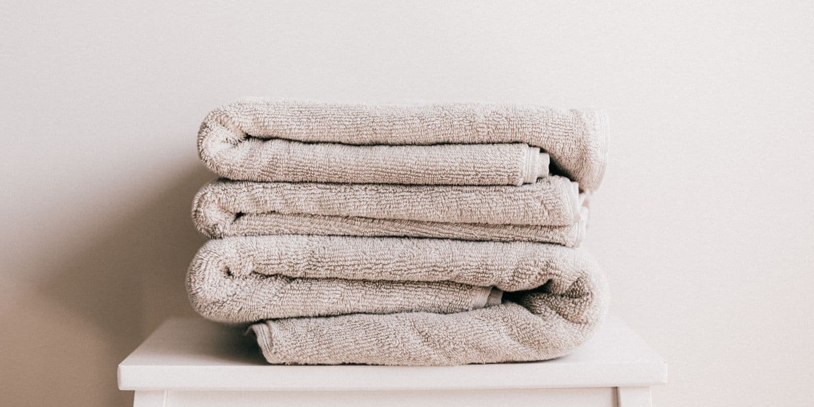 A folded stack of stone-neutral towels