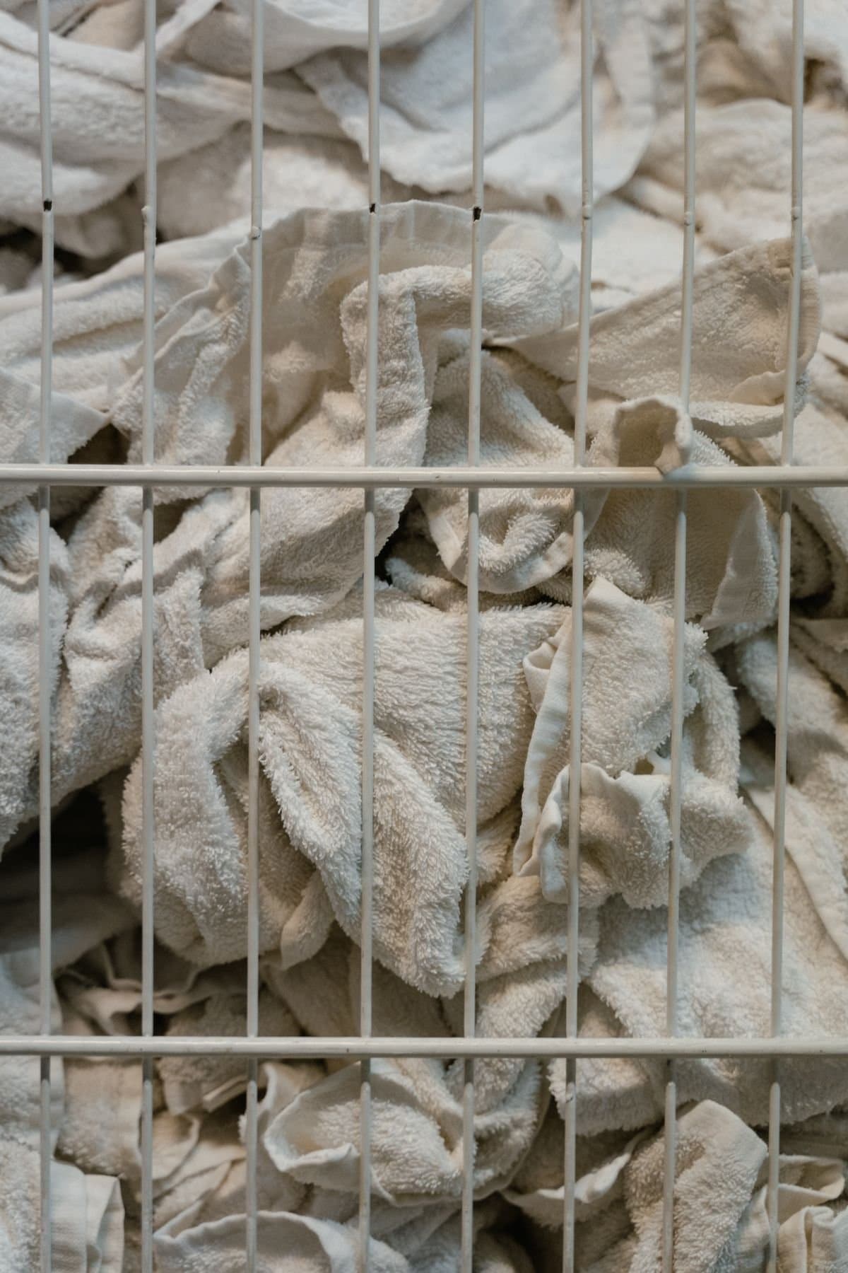 Freshly laundered white towels in a basket