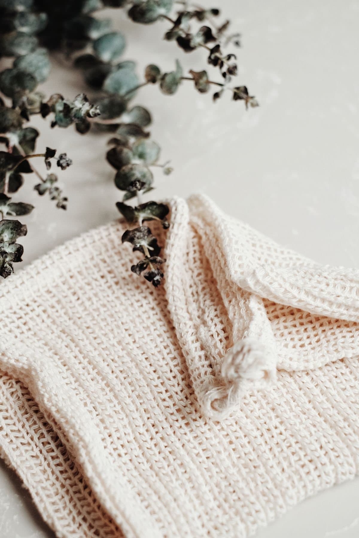 Rolled white washcloths in a basket