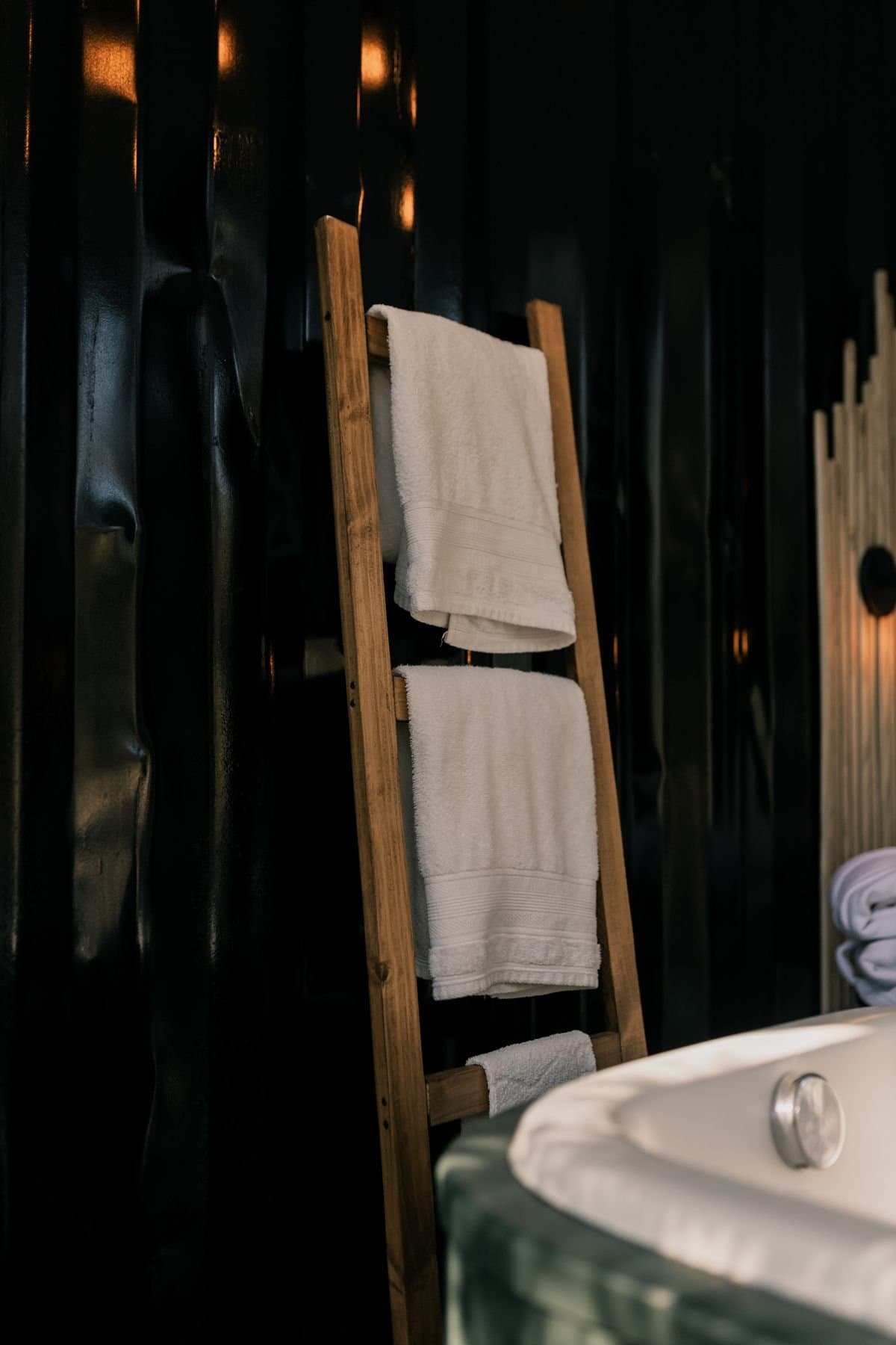 Rolled white guest towels on a vanity