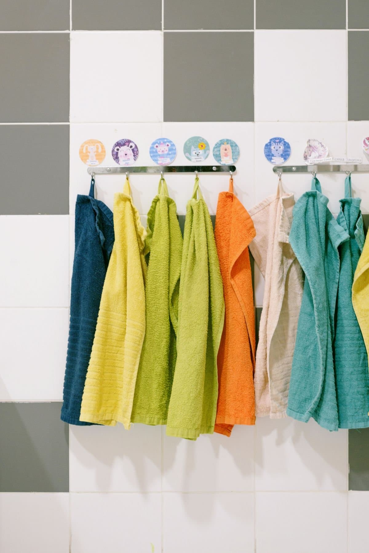 Neutral cotton towels hanging on a wooden rail