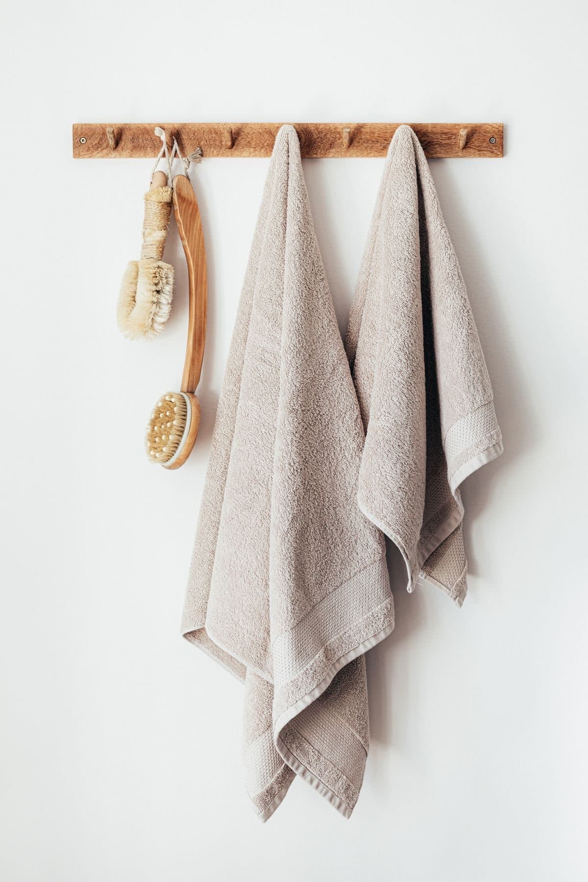 Cotton hand towels hung on a peg rail