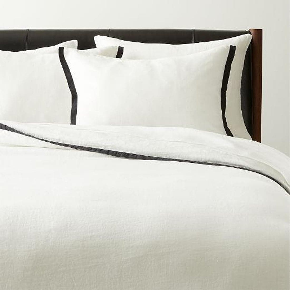 Soft white cotton flat sheet draped in gentle light