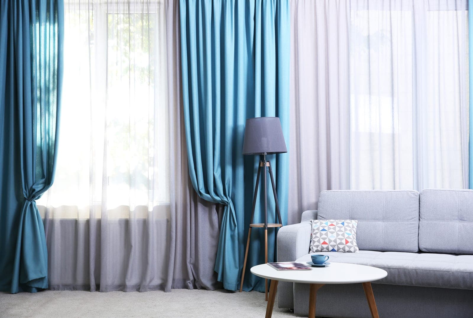 Blue and grey curtains dressing a bright living room