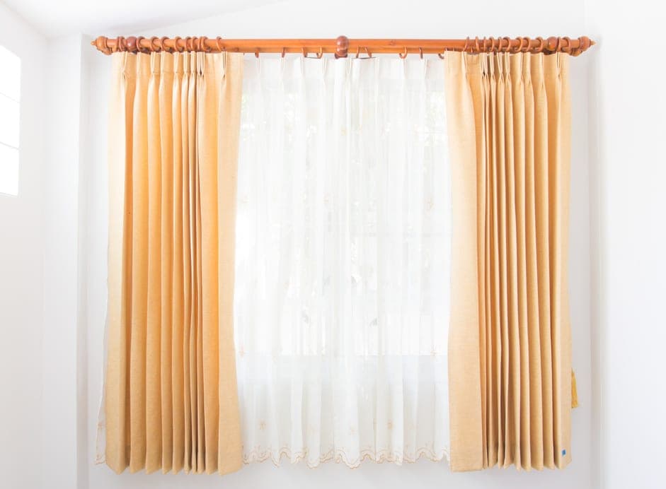 Warm sheer curtains filtering daylight