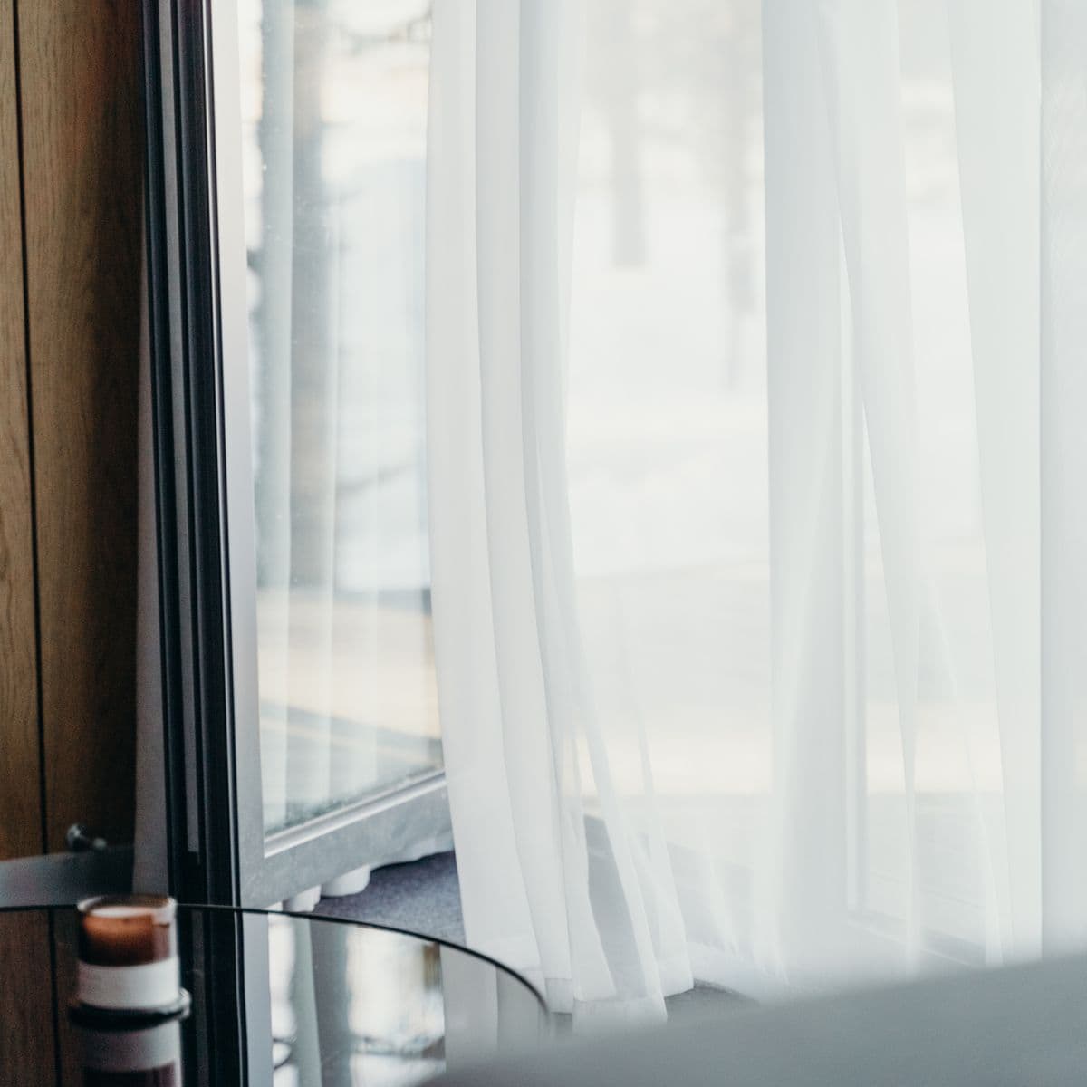 Sleek white sheer drapery at a hotel-style window