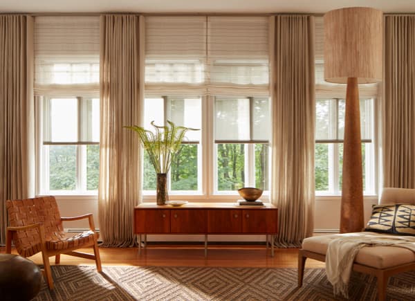 Natural linen ripple-fold drapes in a sunlit living room