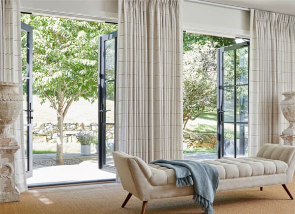 Sand striped pinch-pleat drapes at patio doors