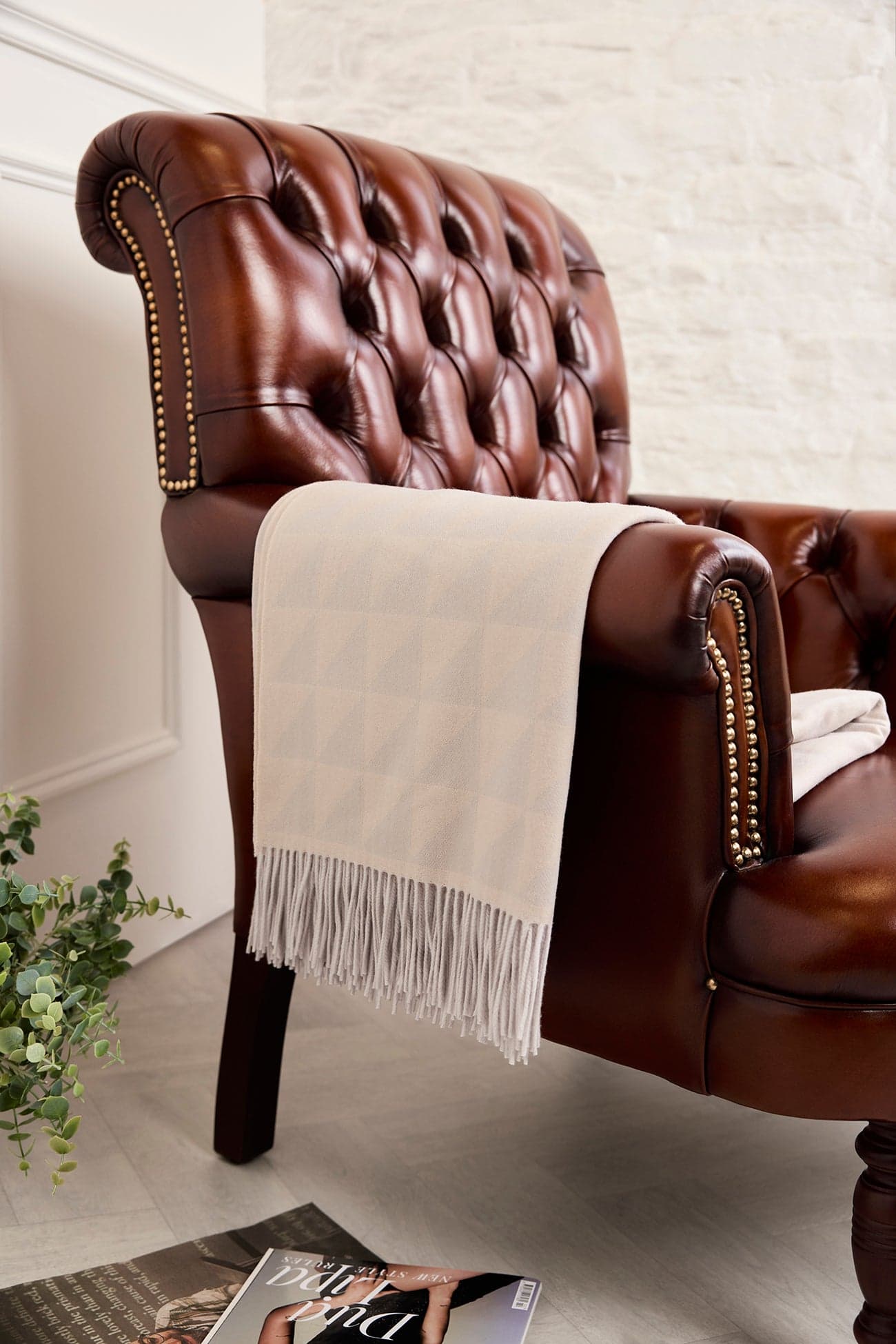 Ivory cream cashmere blanket draped over a chair