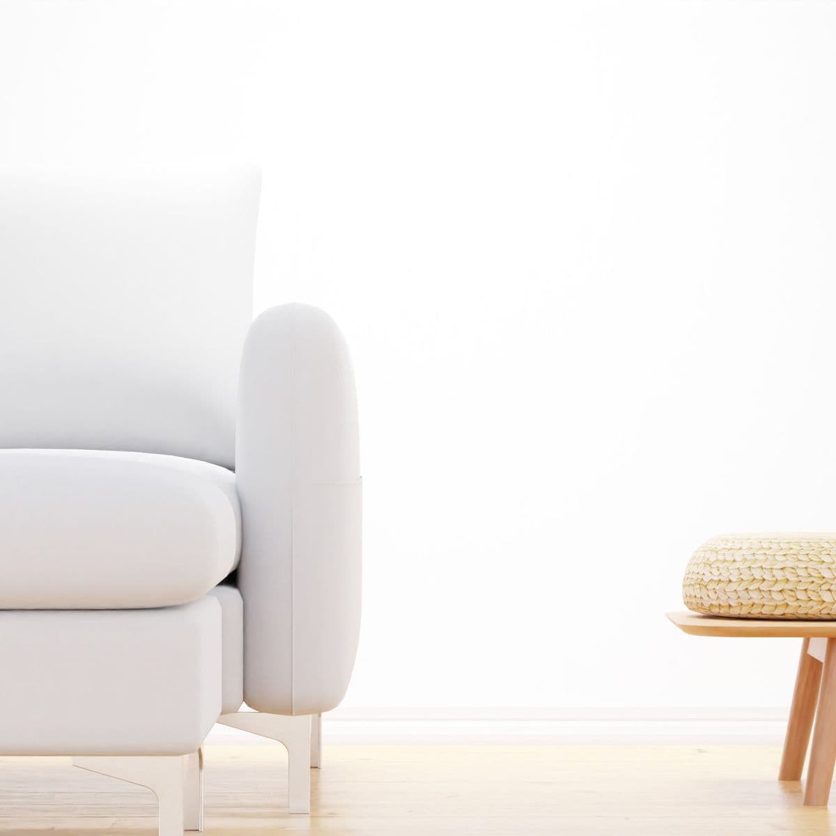 A minimal white sofa in a bright, light-filled room