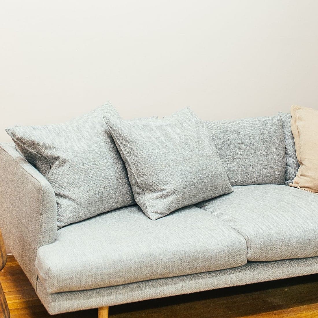 Soft grey textured scatter cushions on a linen sofa
