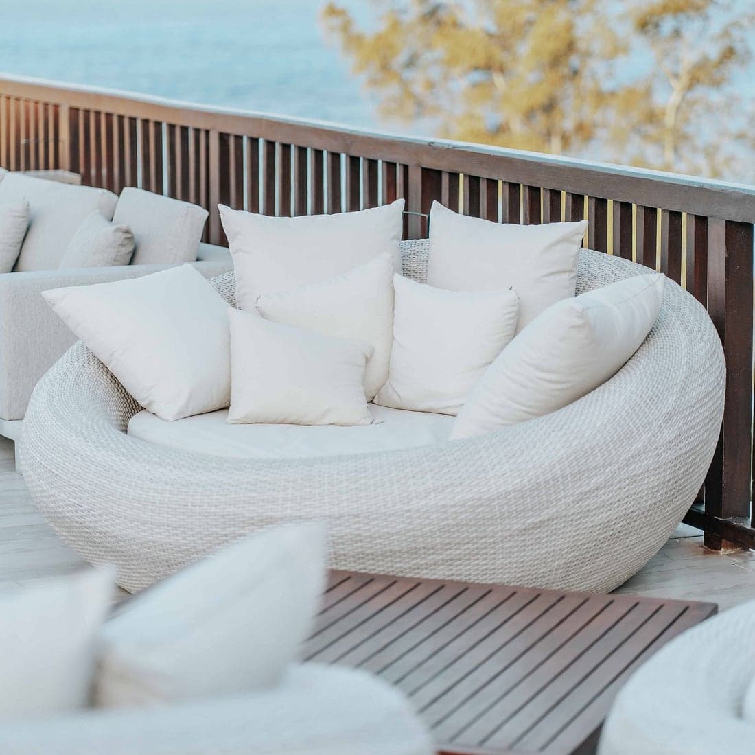 Plump white cushions on a bright resort daybed