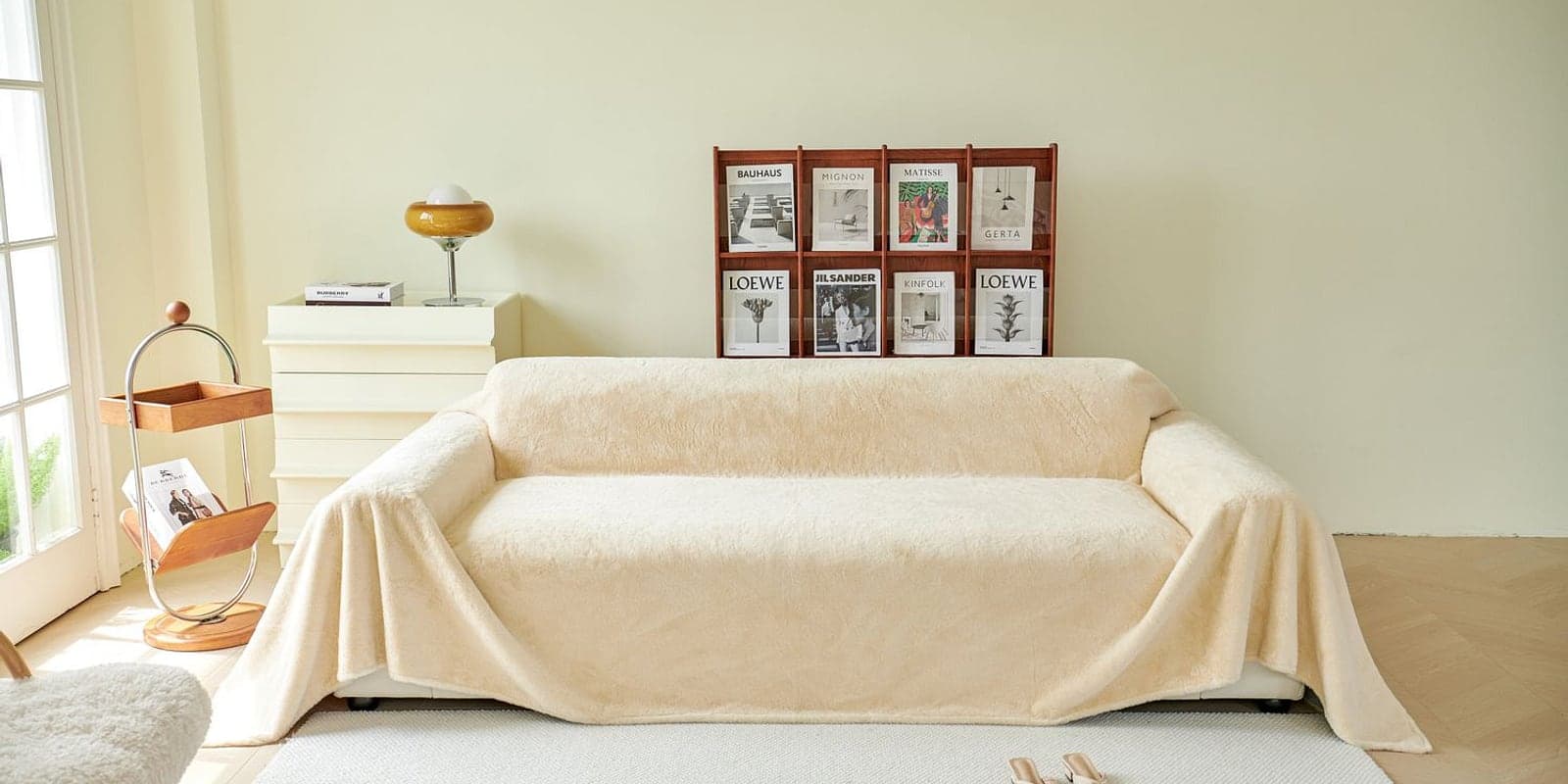 A soft cream throw draped over an ivory sofa