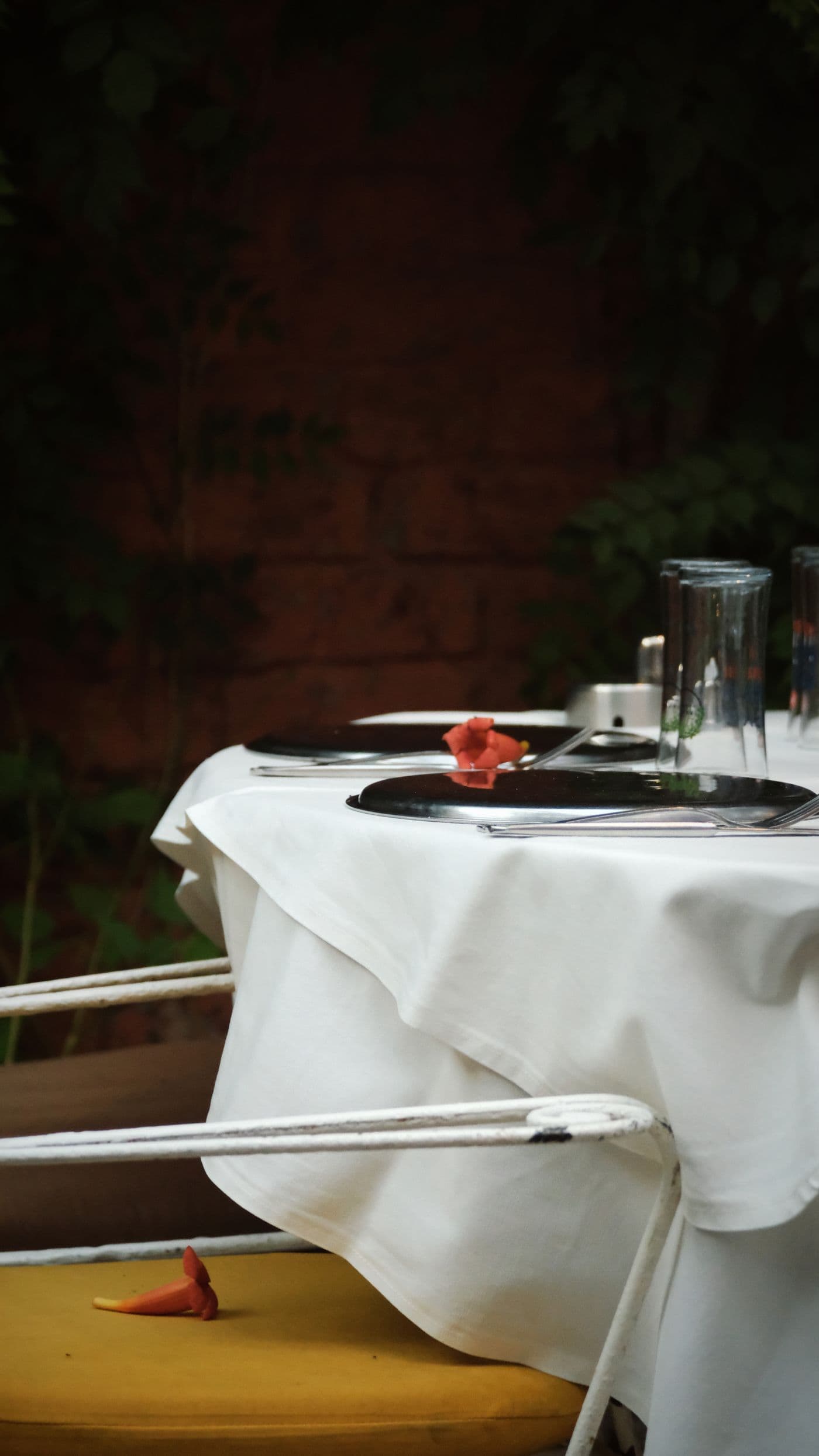 An al fresco table dressed with white linen for dinner