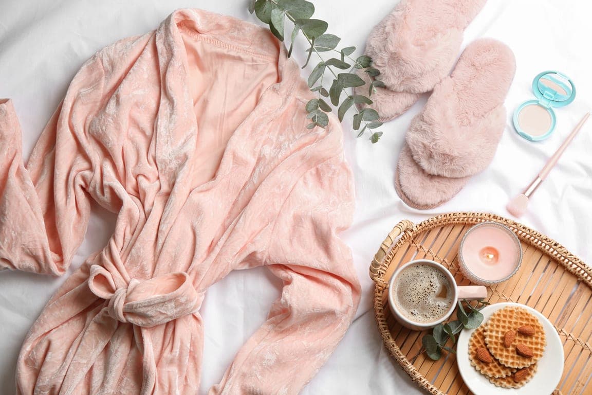 A blush spa bathrobe styled with bath accessories