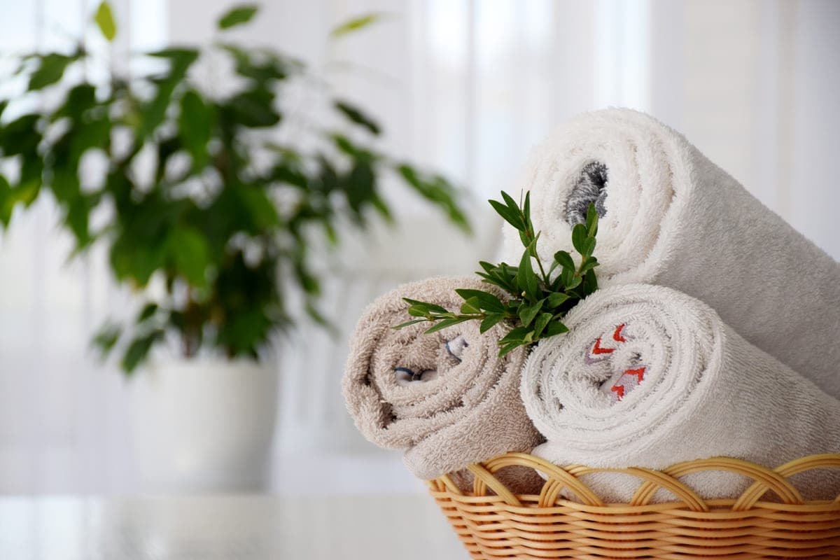 Rolled towels dressed with fresh flowers