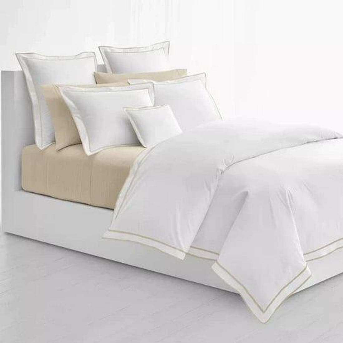 A white sateen-bordered duvet dressed on a bed