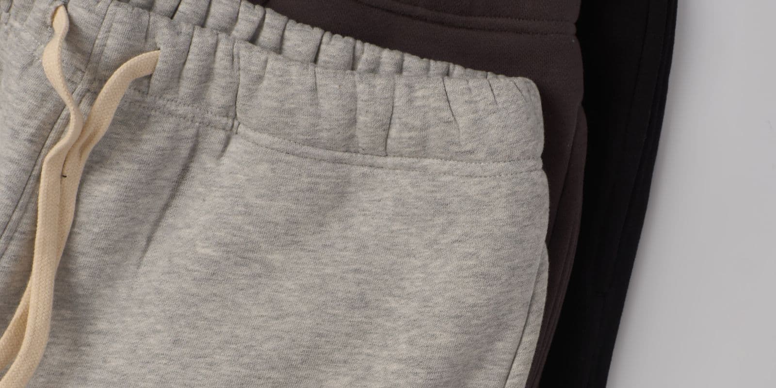 Folded grey, brown and black joggers