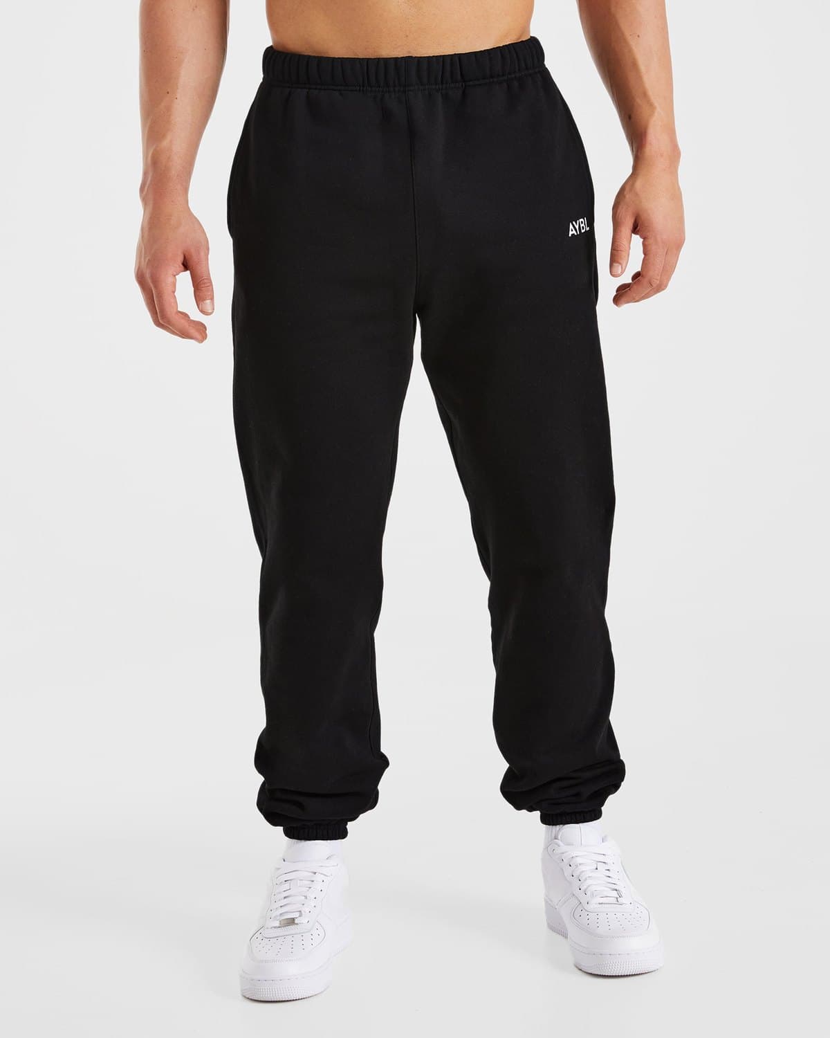 Male model in black Essential cuffed joggers