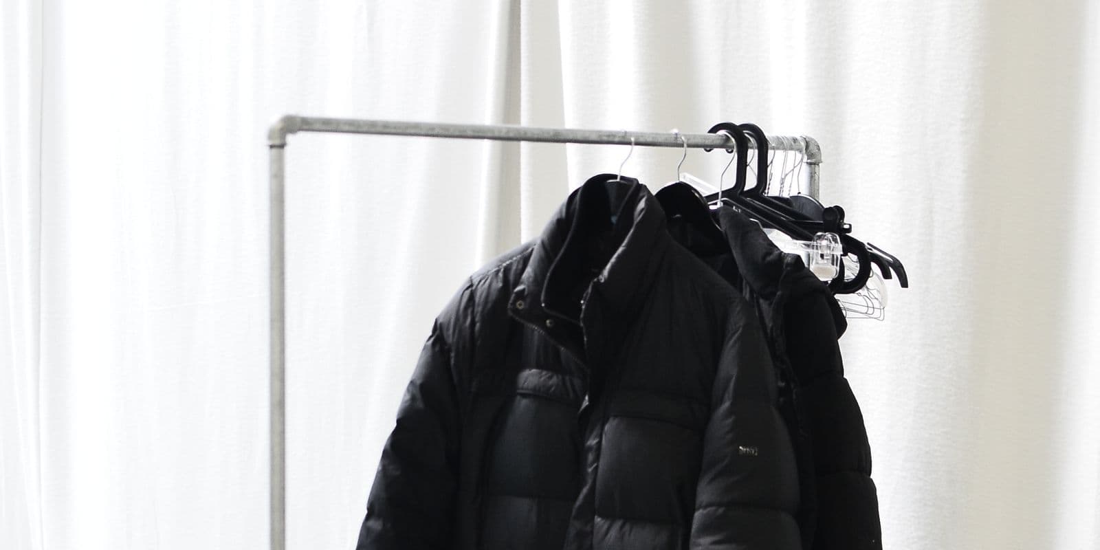Black padded puffer jackets on a rail