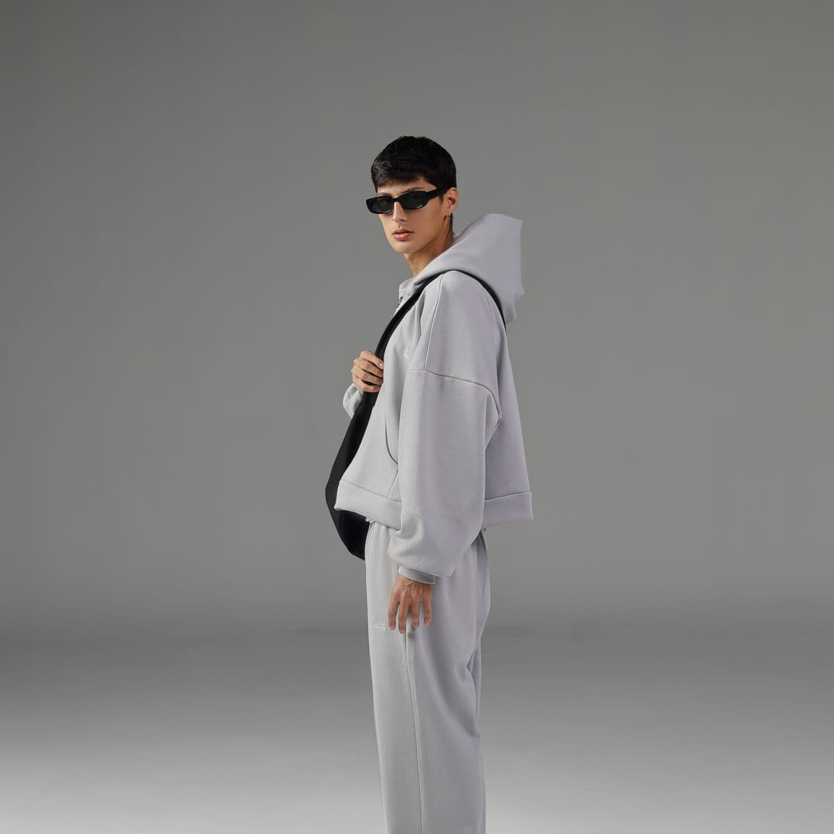 Man in a light-grey zip hoodie and matching joggers