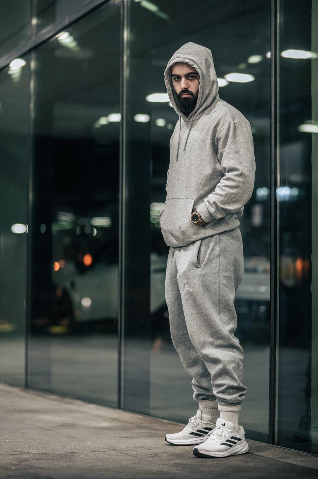 A man in a grey training tracksuit