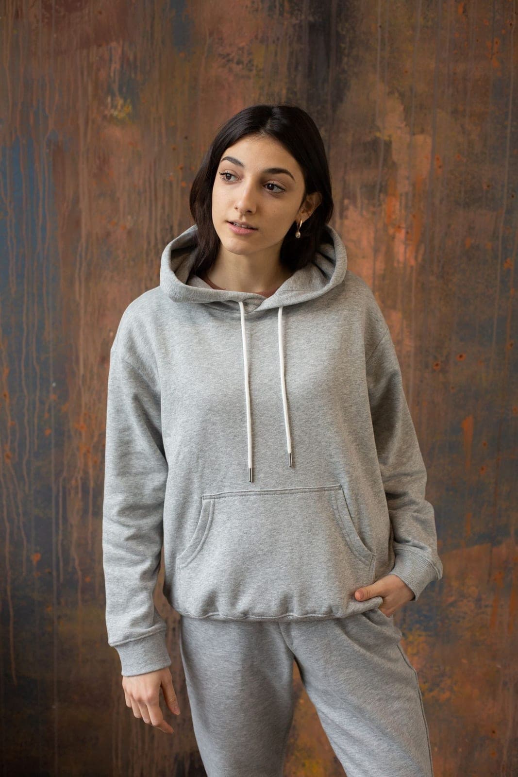 A woman in a grey performance hoodie